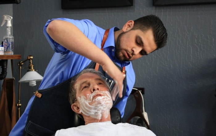 Nick Fontanez gives Mayor Bob Crowell a shave